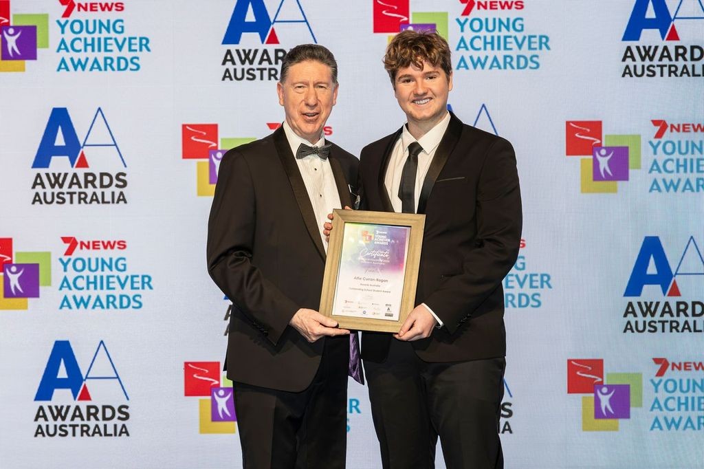 Two people at the 2026 7NEWS Young Achiever Awards holding a finalist certificate.